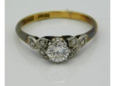 An antique 18ct gold ring with platinum set diamond of 0.5ct with six smaller diamonds on shoulders,