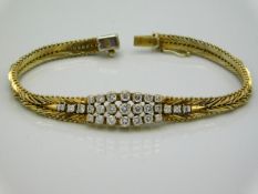 An 18ct gold marked bracelet set with approx. 1.87ct diamonds, some wear to gold colour, tests elect