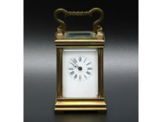 A 19thC. French miniature carriage clock, two chips to bevelled glass, crack to enamel dial, 3in tal