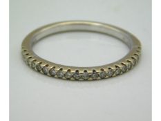 An 18ct gold half eternity ring set with 0.2ct diamonds, 2.1g, size N