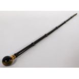 A walking cane with spherical tiger eye handle & gilt mounting engraved "Beatrice", 33in long