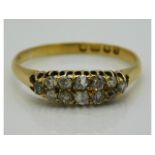 An antique 18ct gold ring set with twelve small diamonds, evidence of glue on end diamond, approx. 0