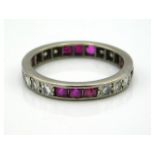 A platinum eternity ring set with ruby & approx. 0.5ct diamond, electronically tests as platinum, 3g