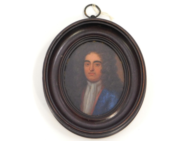 An early 18thC. miniature oil portrait of a gentleman, member of the Churchill family wearing blue c
