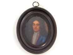 An early 18thC. miniature oil portrait of a gentleman, member of the Churchill family wearing blue c