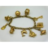 A 9ct gold & yellow metal charm bracelet, 26.1g