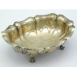 A white metal footed dish of organic form, tests as silver, 100g