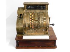 A Victorian brass cash register, damage to glass, piece in drawer, missing side till roll panel