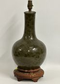 A 19thC. Chinese porcelain vase on rosewood base with organic & floral decor on unusual ivy green gr