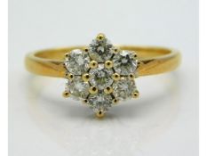 An 18ct gold daisy ring set with approx. 0.7ct diamonds, 3.5g size M/N