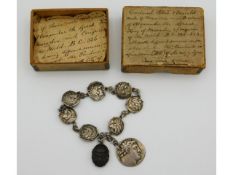 A silver coin bracelet made up with seven mounted Alexander the Great drachmas & one holed, dating B