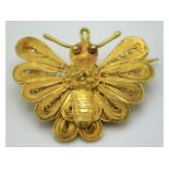 A 19thC. gold filigree work moth brooch, possibly Georgian, electronically tests as 18ct, 37mm wide,