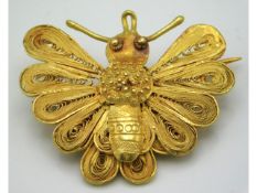 A 19thC. gold filigree work moth brooch, possibly Georgian, electronically tests as 18ct, 37mm wide,