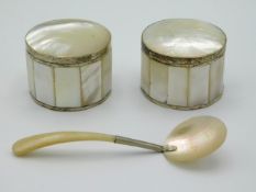 A pair of white metal mounted mother of pearl lidded boxes twinned with mother of pearl caviar spoon