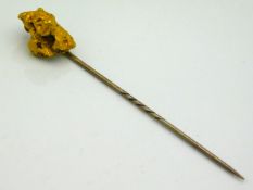 A gold tie pin set with ingot, 72.5mm long, with original box, pin electronically tests as 9ct & nug