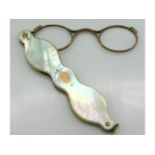 A pair of gold framed mother of pearl lorgnettes, 4.25in wide folded, electronically test as 14ct, 3