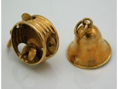 A gold tambourine charm twinned with bell charm, test electronically as 18ct, 2.57g
