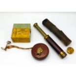 An early 20thC. small brass telescope with case twinned with Rabone measuring tape with original box
