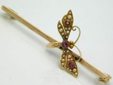 A gold bar brooch with moth decor set with pearl & pink sapphire, bar tests electronically as 9ct, t