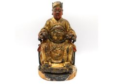 A Chinese gilt lacquered wood figure of an immortal, 9.5in tall