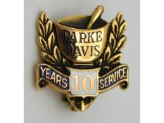 A 10ct gold enamelled Parke Davis ten years service brooch, 2.2g