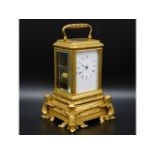 A good 19thC. French repeating carriage clock by Aubert & Co. with engraved decor & ornate stand wit