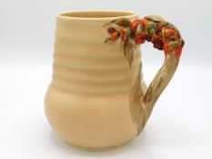 A Clarice Cliff jug with organic floral handle, pattern no. 811, 6.5in tall