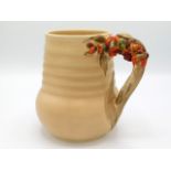 A Clarice Cliff jug with organic floral handle, pattern no. 811, 6.5in tall