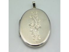 An engraved silver locket by J. A. Main Ltd, 40mm high, 16.6g