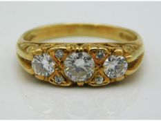 An antique 18ct gold ring set with three main diamonds & four small, approx. 0.55ct total, 3.9g Size