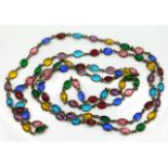 An antique gilt necklace set with coloured glass stones, 52in long