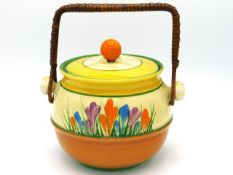 A Clarice Cliff Bizarre crocus design biscuit barrel, 5.75in high to lid finial