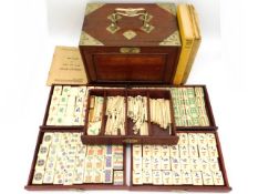 An early/mid 20thC. cased Chinese five drawer bone Mahjong set twinned with various instruction manu