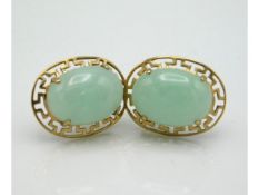 A pair of 9ct gold jade earrings with Oriental styled mounts, stones 11mm high, 4.1g