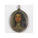 A 17thC. oil miniature of young gentleman wearing lace collar set within a chased silver frame. Imag