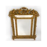 A 19thC. gesso framed mirror with cherub decor, 37.5in at highest x 26.5in at widest