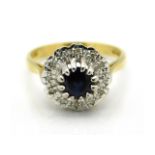 An 18ct gold ring set with diamond & central sapphire, 4.4g, size M