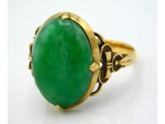 A 9ct closed back ring set with jade stone measuring 17mm x 12mm, size O/P, 5.2g