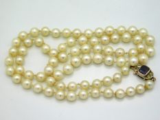 A cultured pearl necklace with 14ct gold clasp set with paste stones, 23in long, 30.6in