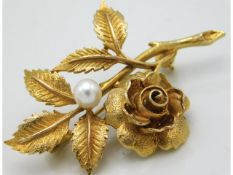 A gold brooch of organic form with rose set with cultured pearl, electronically tests as 9ct, 8g