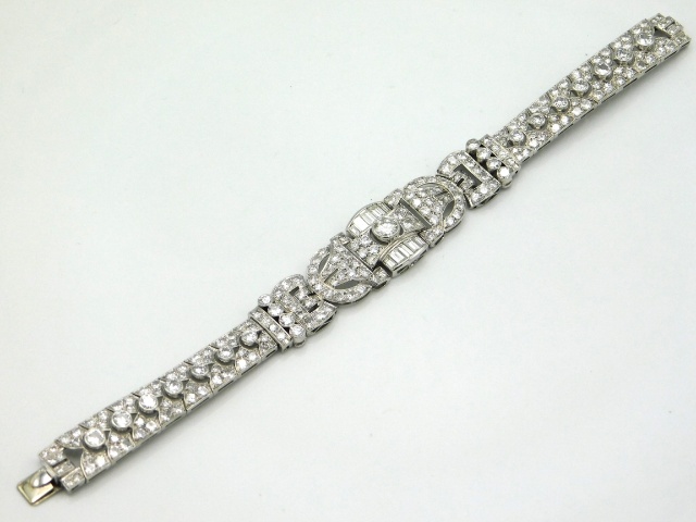 An impressive 1920's white gold bracelet set with approx. 12ct bright, lively diamonds, central ston