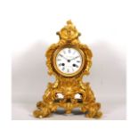 A 19thC. French Louis XV style ormolu striking mantle clock, runs when wound, 13in high
