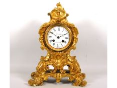 A 19thC. French Louis XV style ormolu striking mantle clock, runs when wound, 13in high