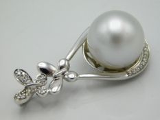 A certificated large South Sea cultured pearl mounted in 18ct gold, set with diamonds, metal weight