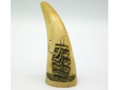 An antique scrimshaw sperm whale tooth, 3.25in tall, two splits