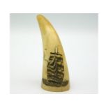 An antique scrimshaw sperm whale tooth, 3.25in tall, two splits