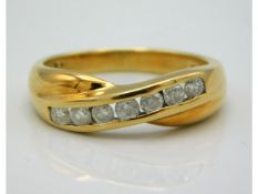 An 18ct gold crossover ring set with seven diamonds of 0.5ct, 4.4g, size Q