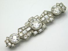 An impressive 1920's platinum brooch set with approx. 6ct of bright, lively diamonds, the larger sto