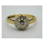 An 18ct gold daisy style ring set with thirteen illusion set diamonds, 3.4g, size O