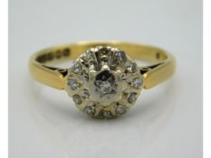 An 18ct gold daisy style ring set with thirteen illusion set diamonds, 3.4g, size O